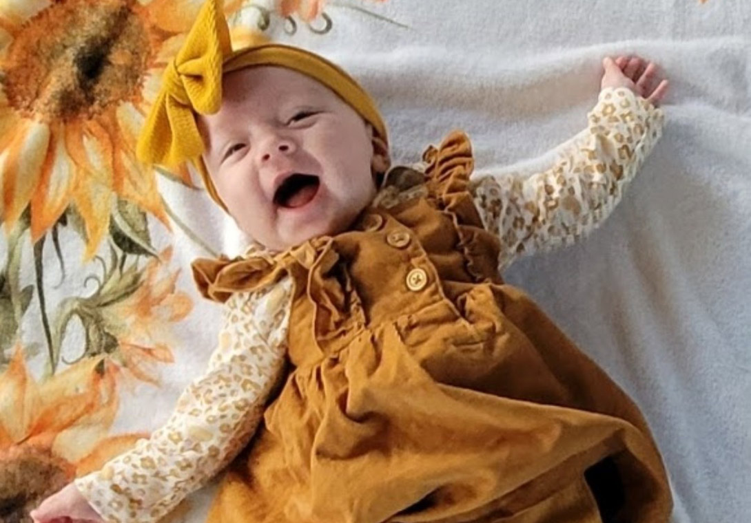 happy baby in yellow